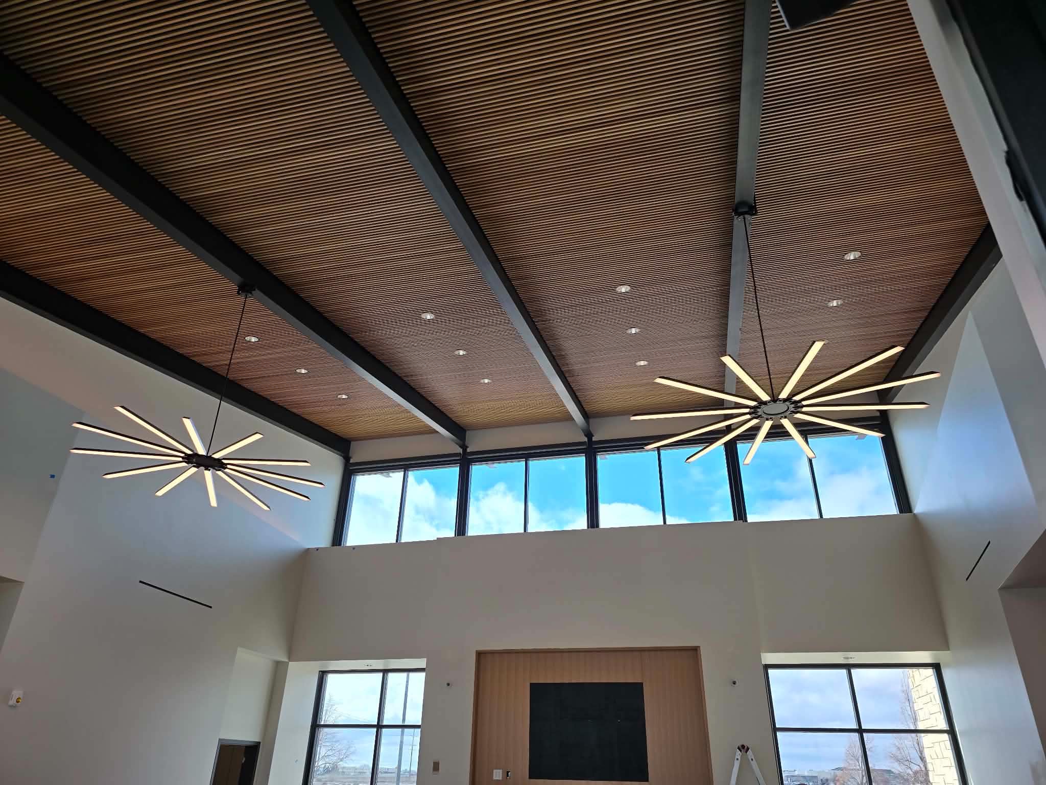 Statement lighting under a slat wood ceiling